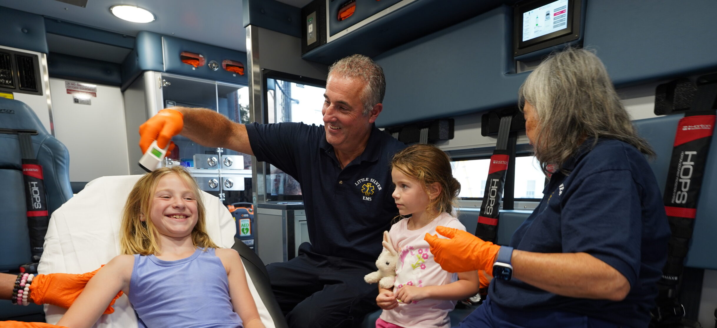 EMT Gene checking on patient in ambulance